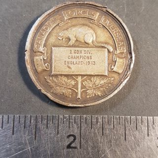 #65 1943 Canadian Forces Overseas golf medal - embossed on the obverse with golfing figures and on the reverse tengraved â??1st CDN Army Troops - runners Up - England 1943"